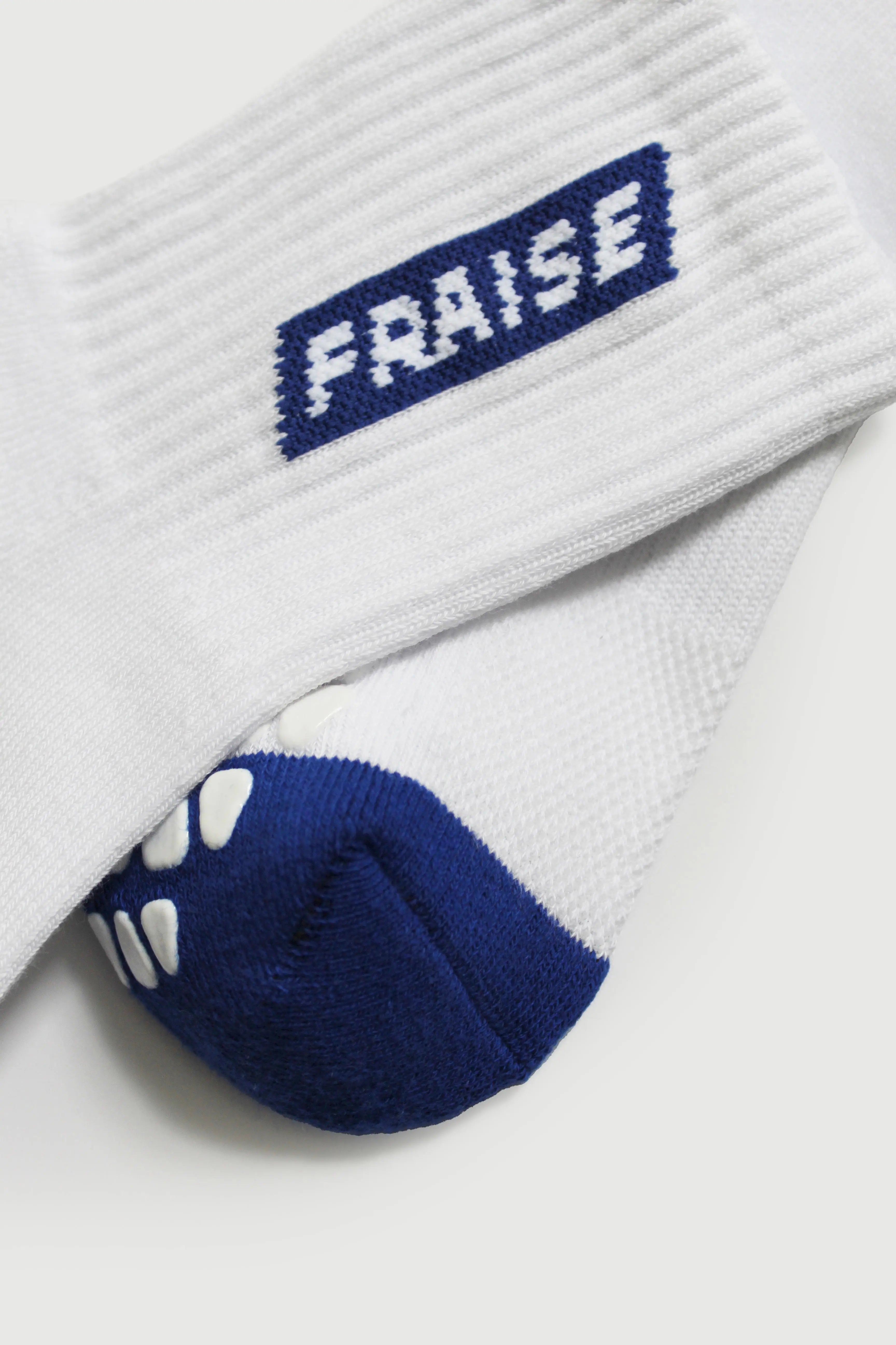 Pair of Fraise branded pilates grip socks in white and blue