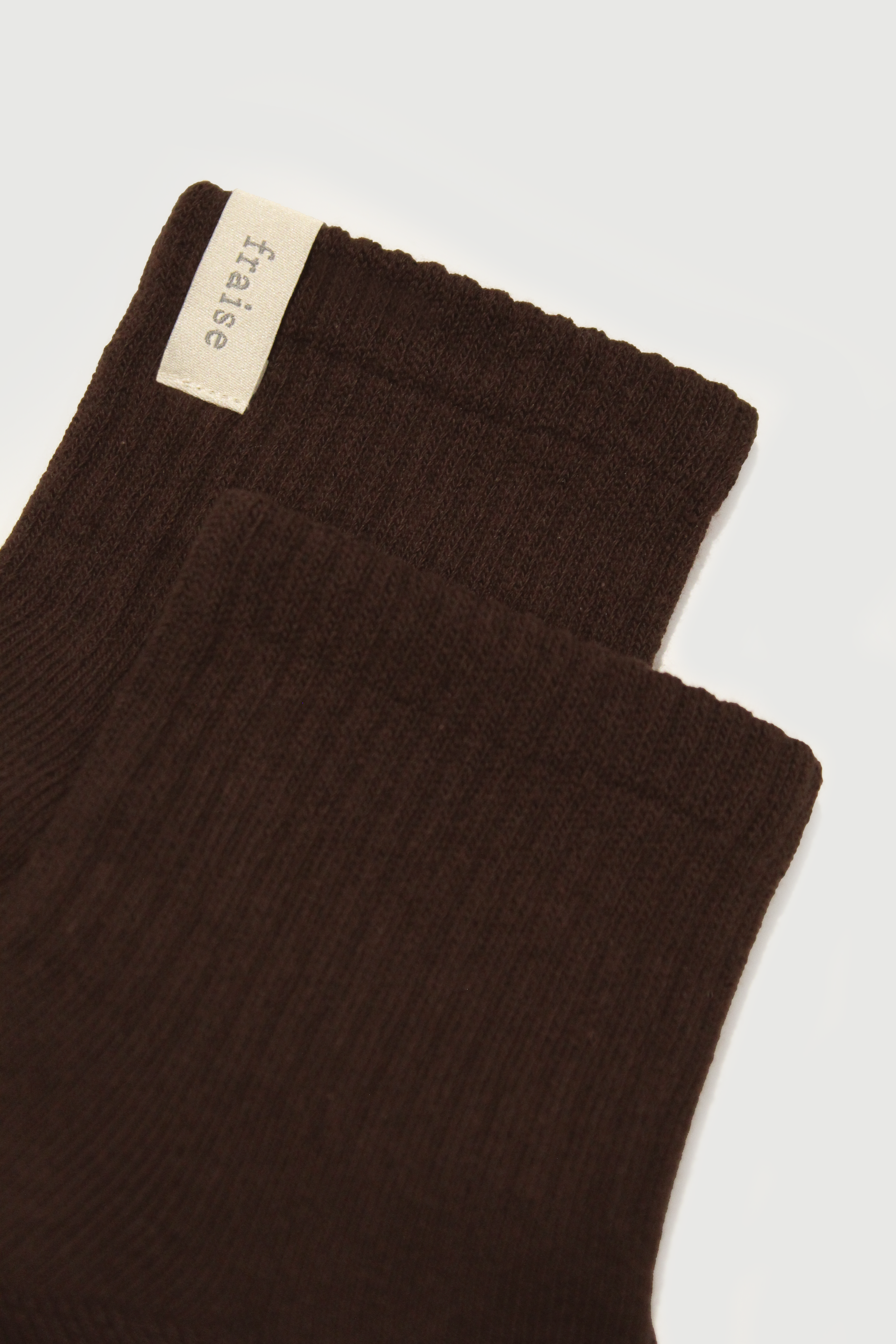 Close up of espresso brown quarter length socks showing 'fraise' label