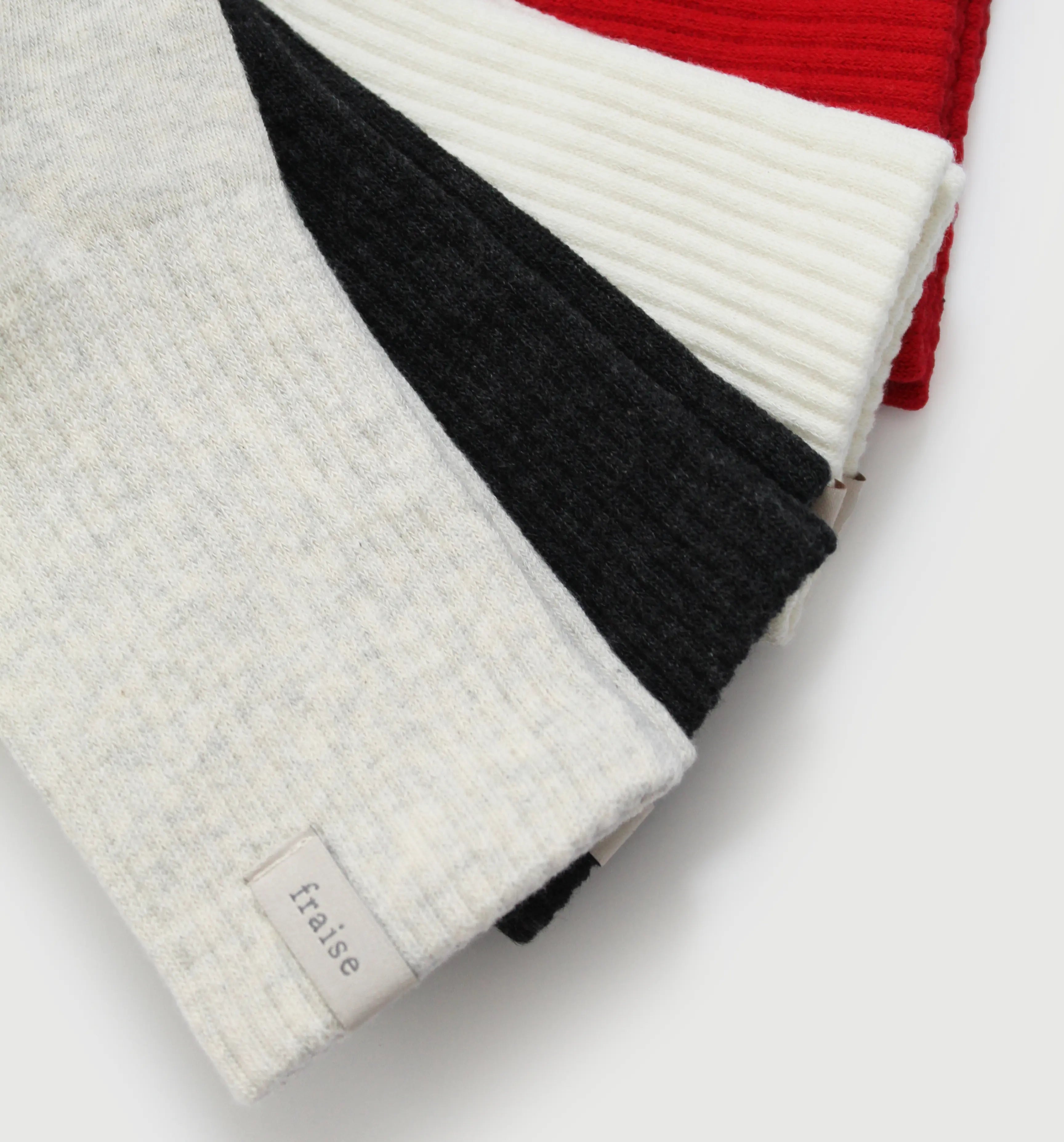 Four pairs of pilates grip socks in heather, dark grey, cream, and red