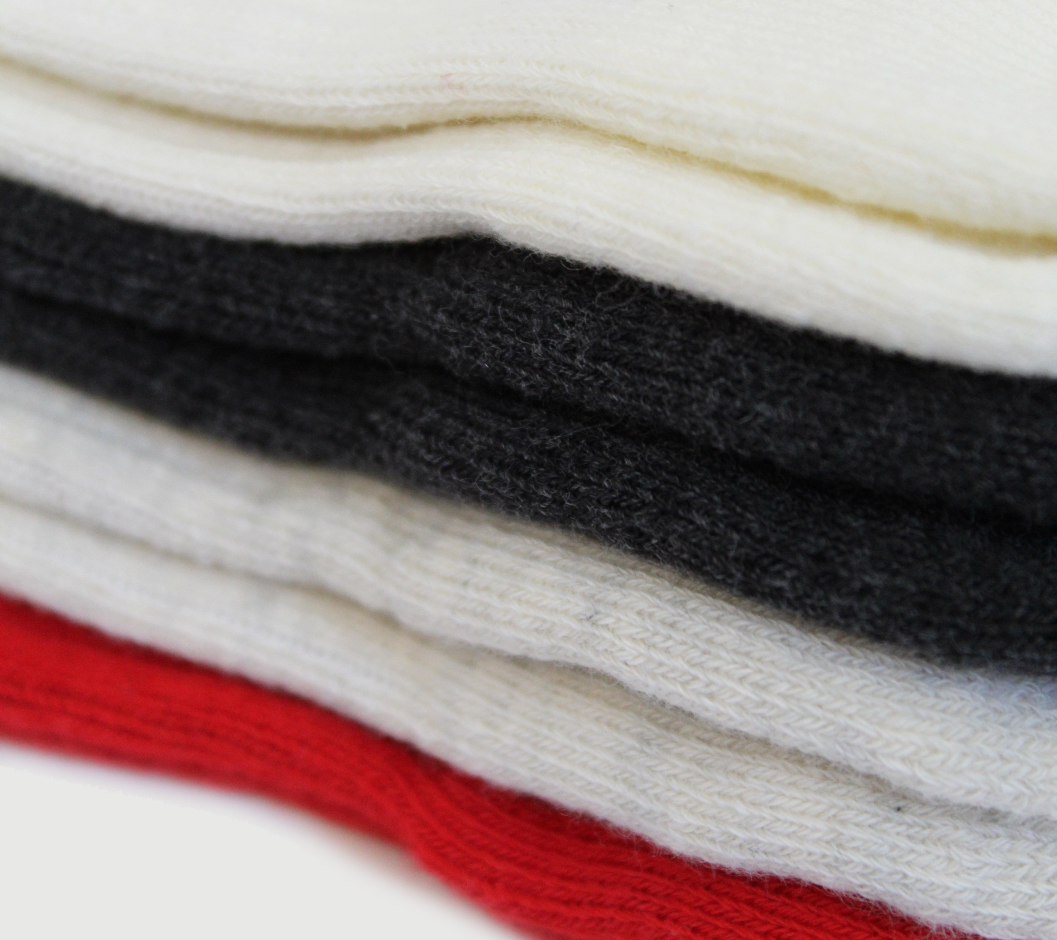 Stack of folded fraise LA grip socks in various colors including red, black, and white on a white background.