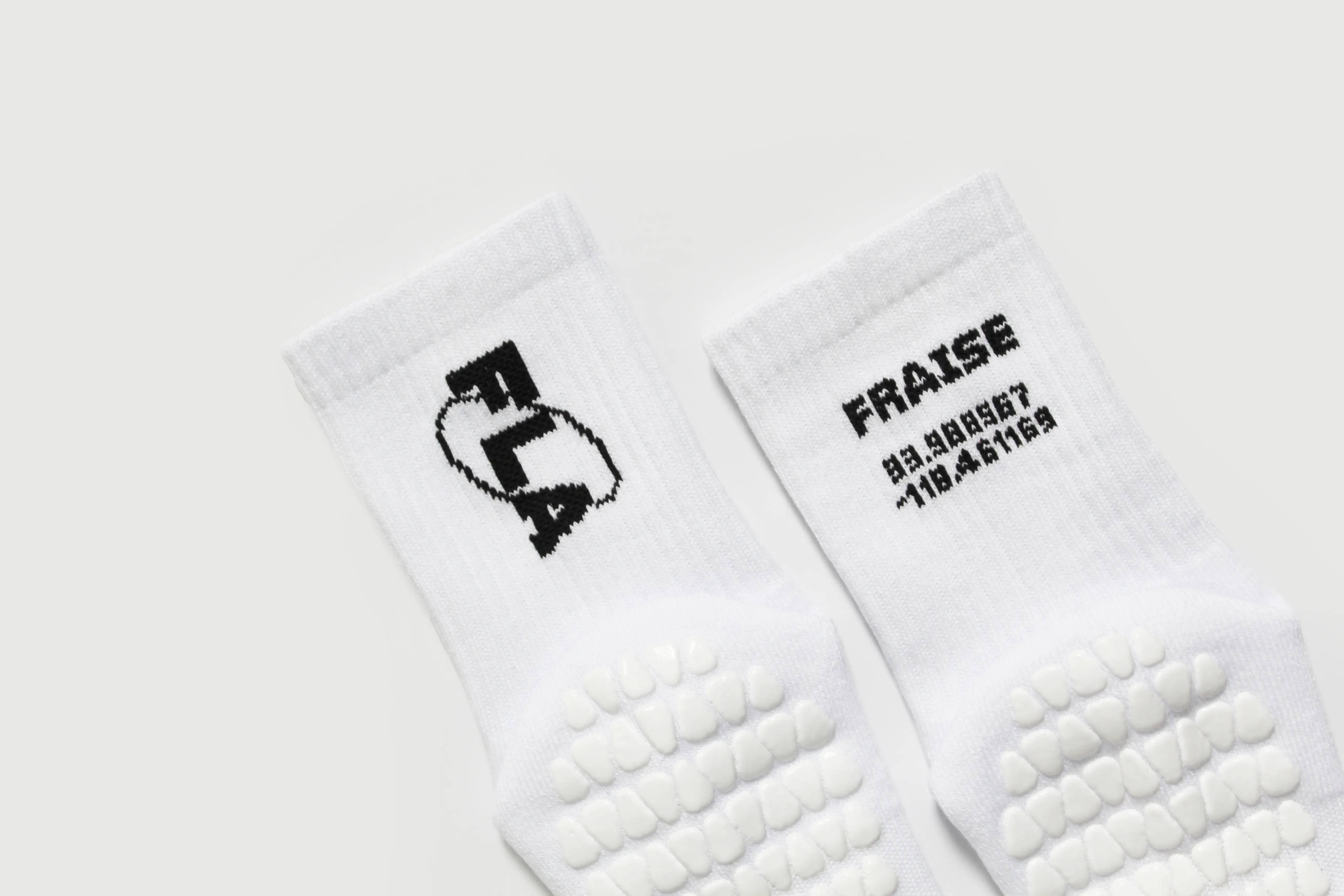 Pair of white Fraise branded pilates grip socks