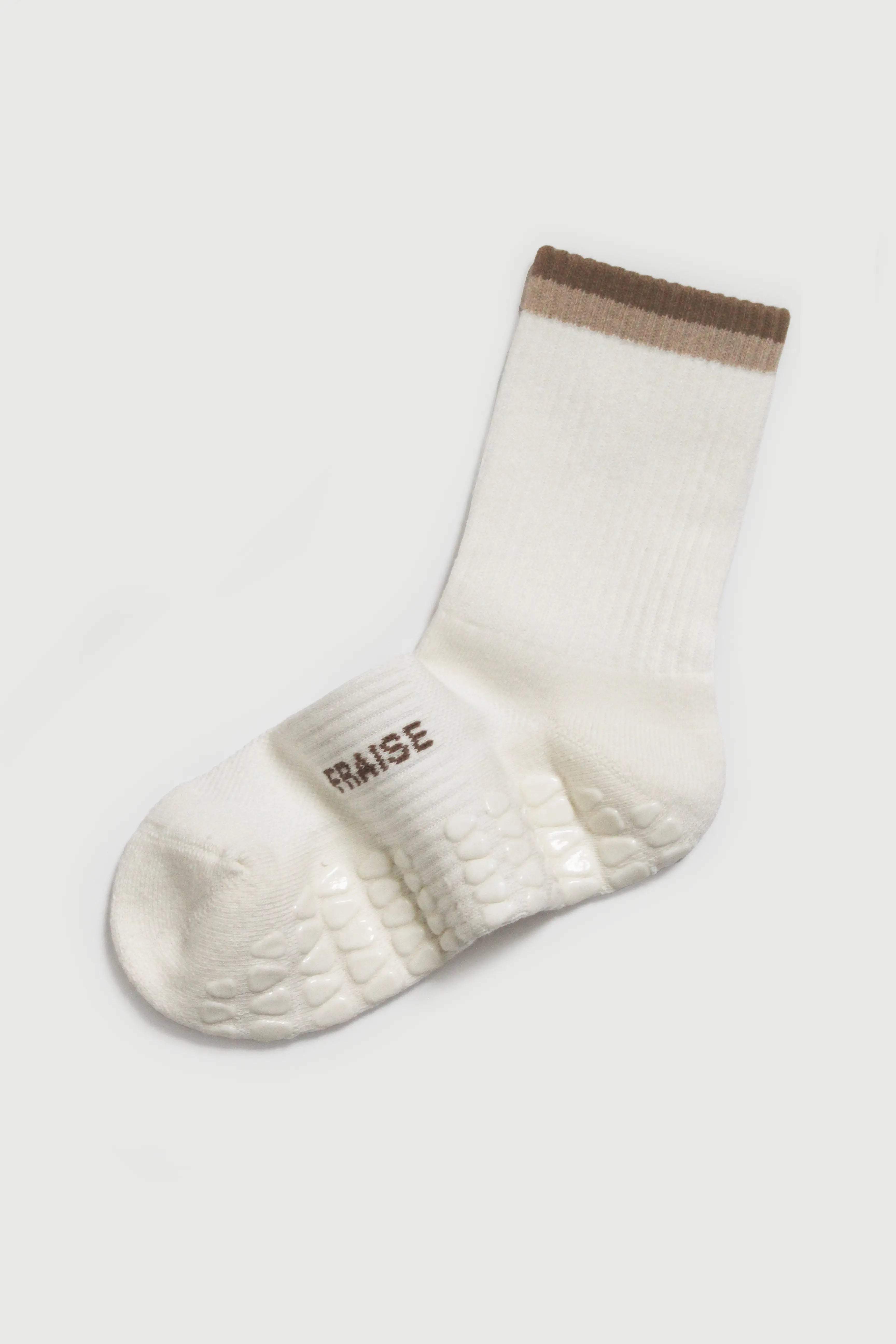 White pilates grip sock with brown stripe on cuff on a white background