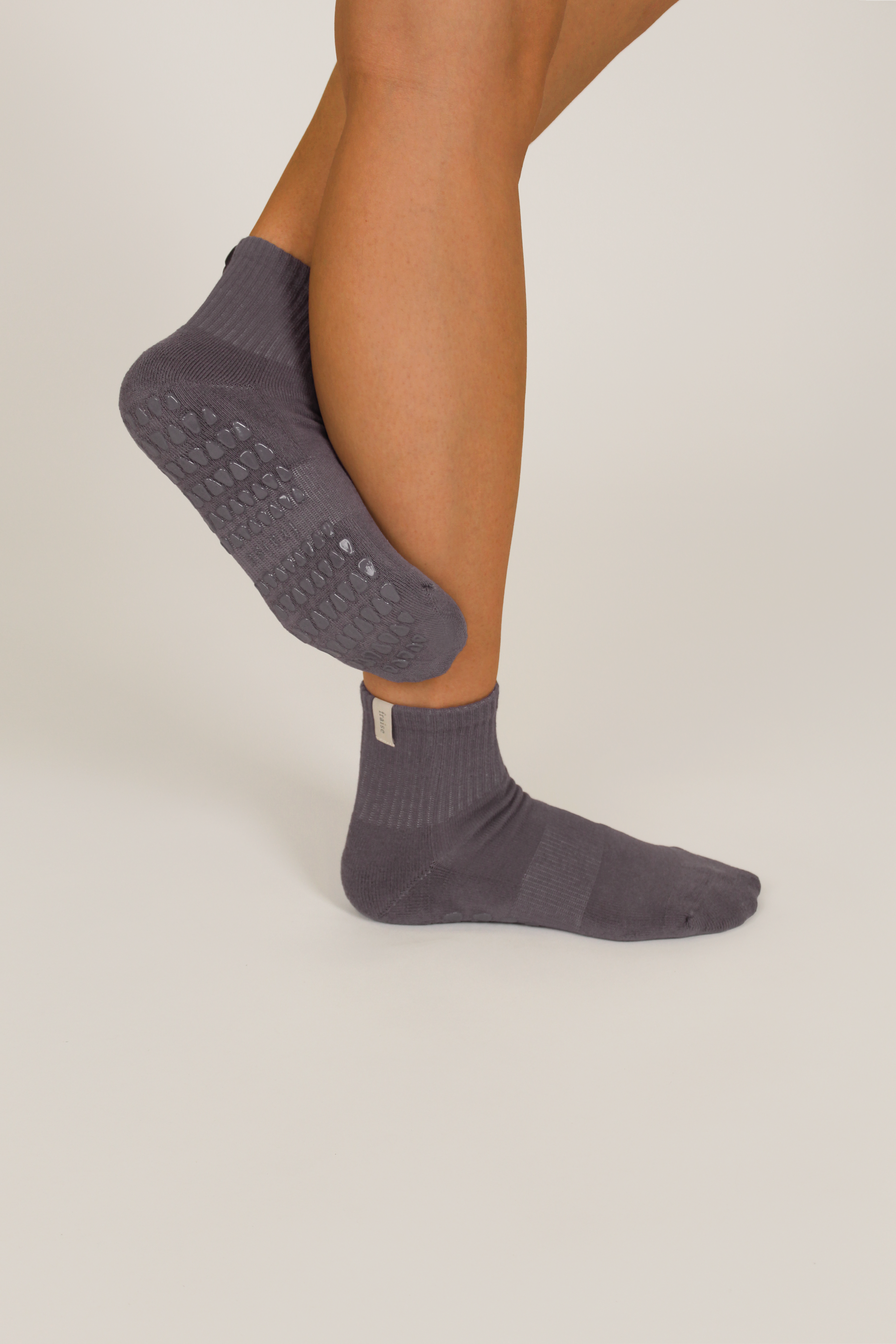 Person wearing mineral grey quarter length grip socks