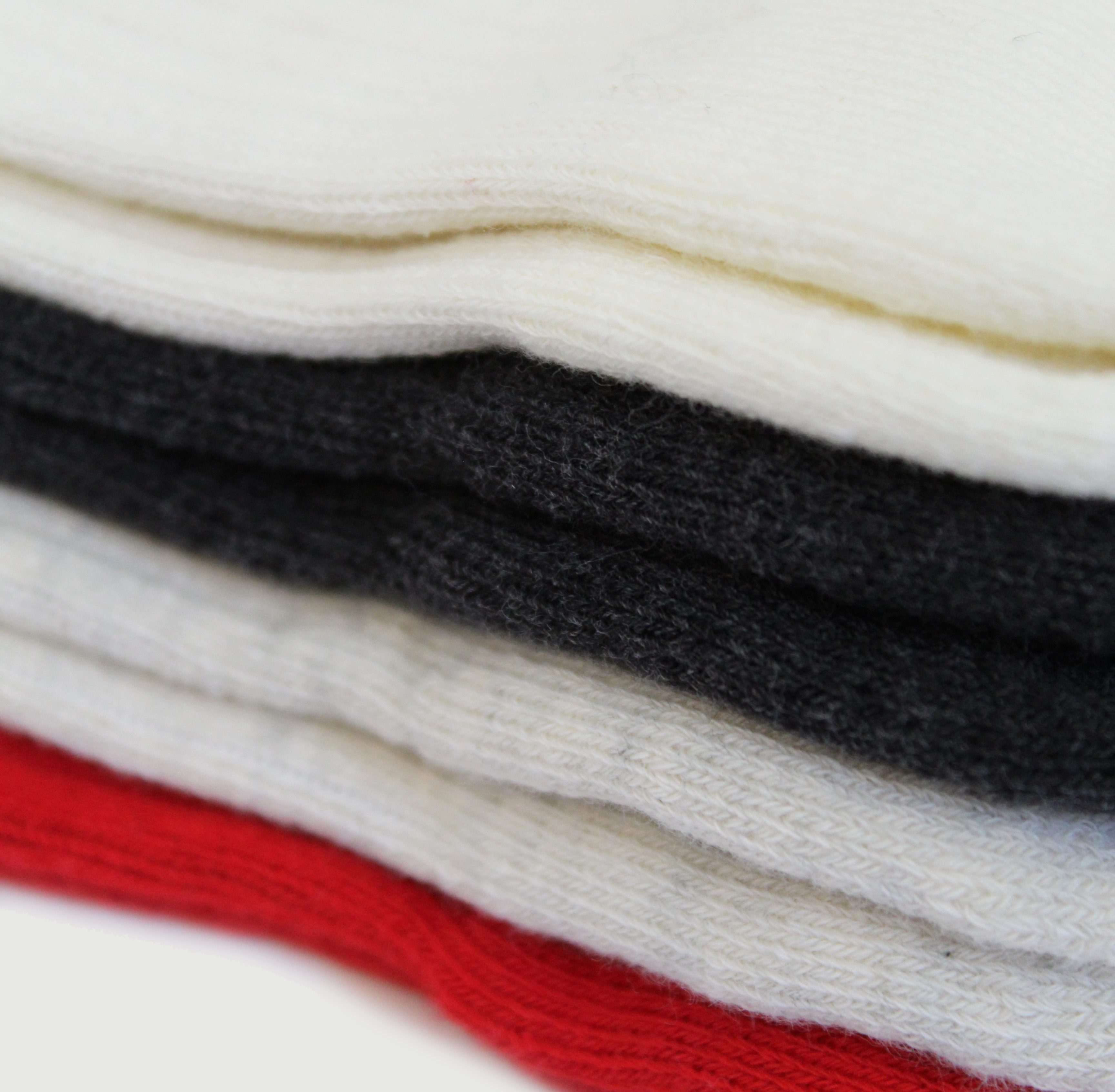 Stack of folded fraise LA grip socks in various colors including red, black, and white on a white background.
