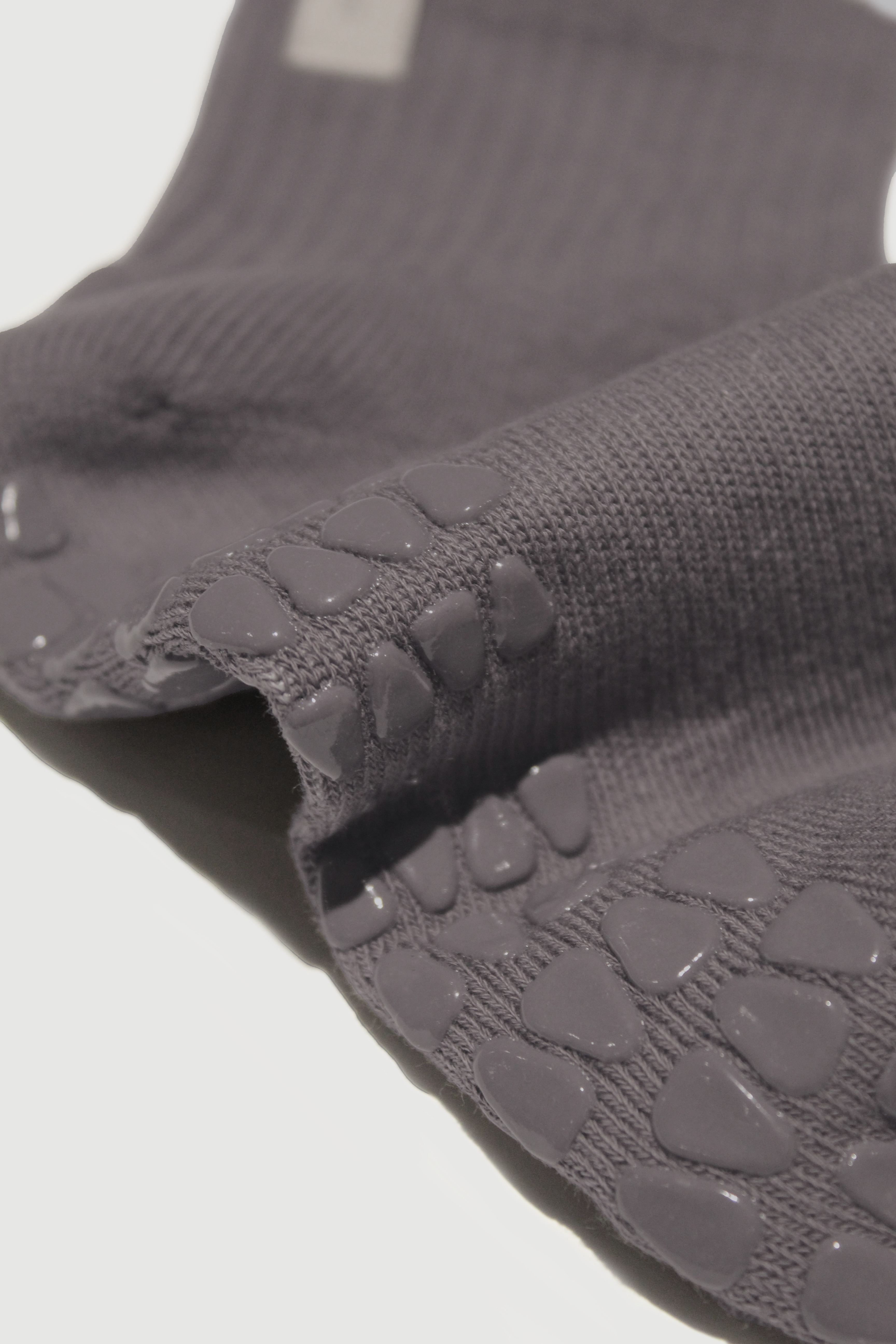 Close-up of mineral grey grip socks showing grips on sole