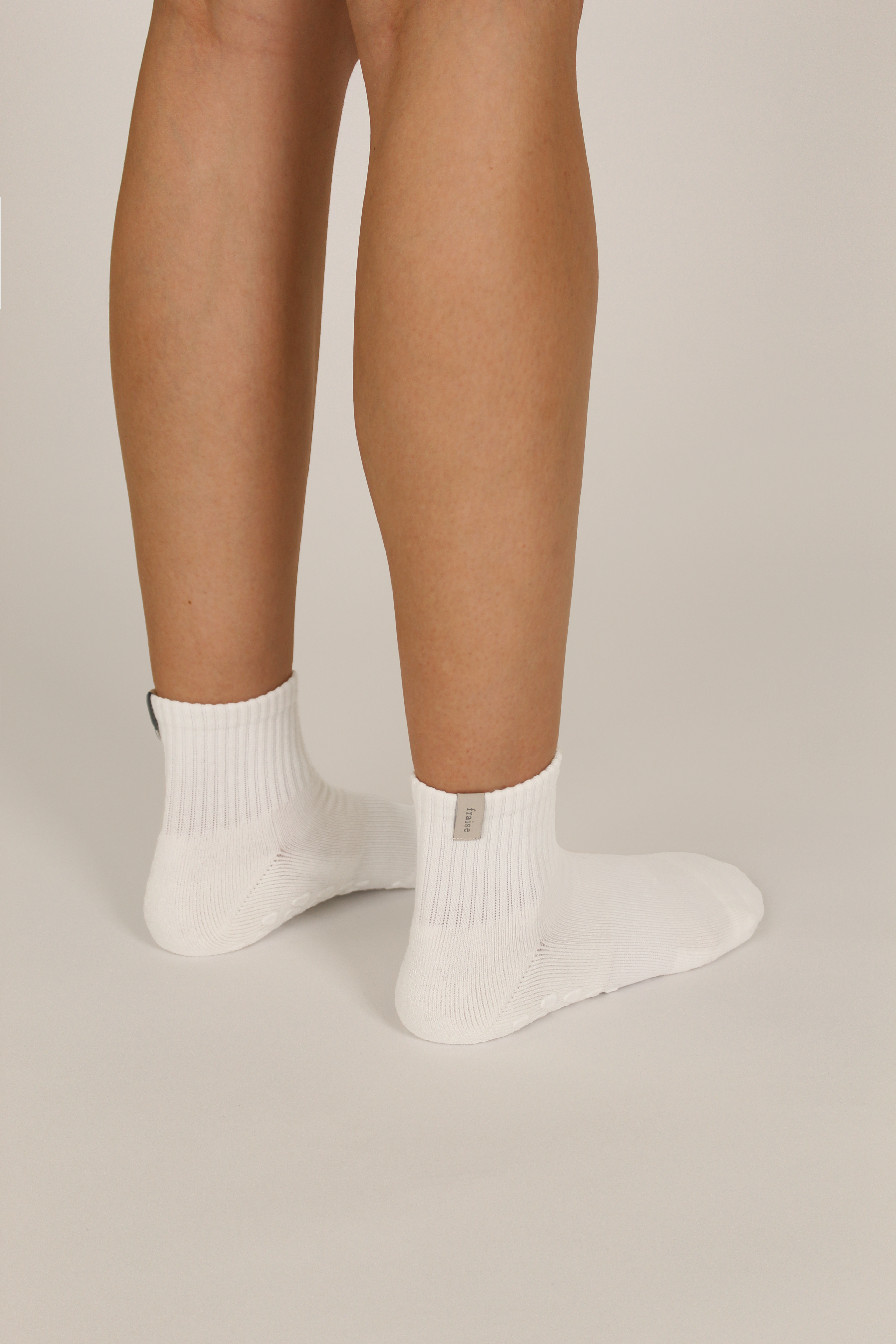 Person wearing white pilates grip socks